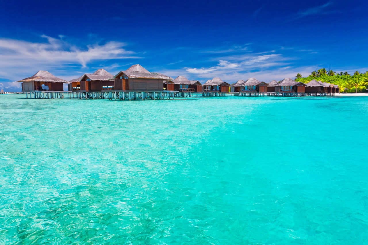 Anantara Veli Maldives' overwater bungalows above a turquoise lagoon, South Malé Atoll