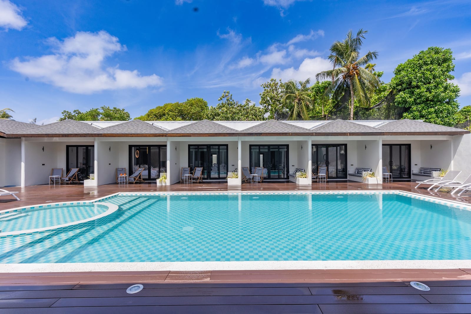 Hakuna Maldives outdoor pool and palm garden