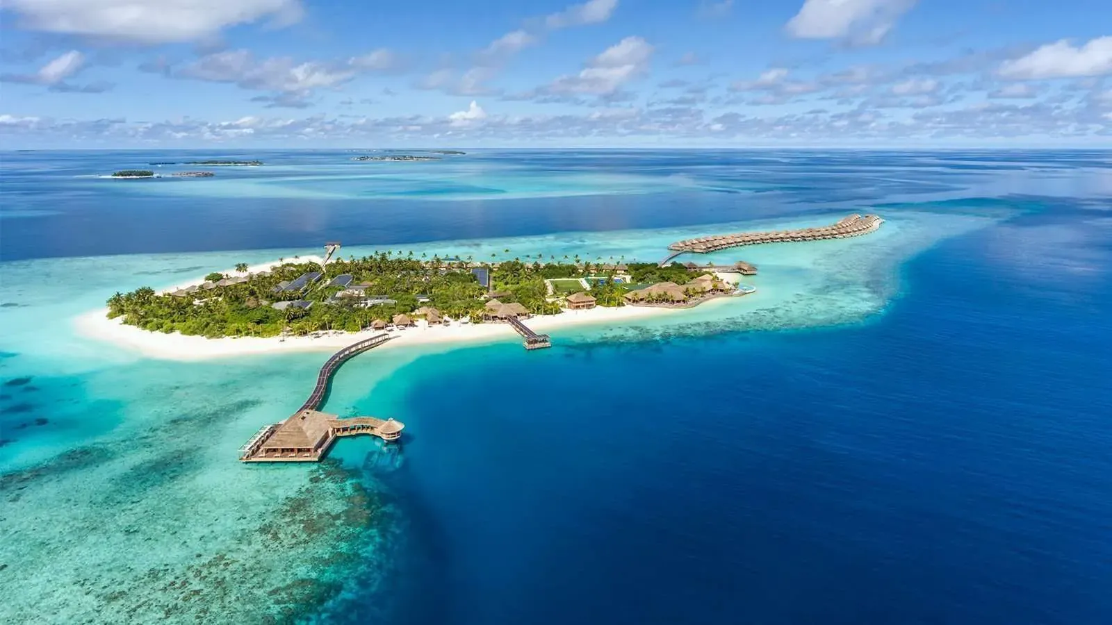 Aerial view of Hurawalhi Island Resort's overwater villas in Lhaviyani Atoll