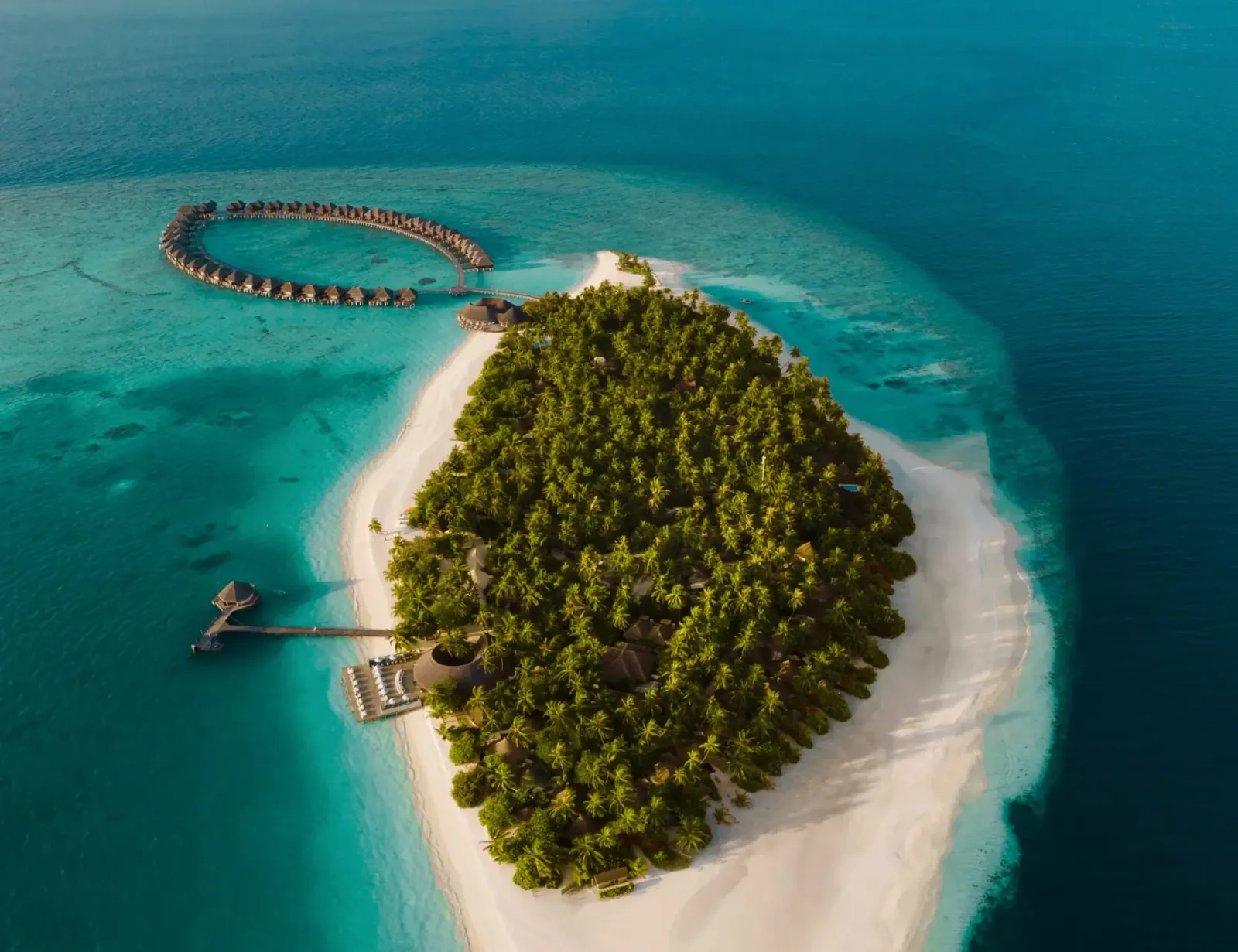 Sun Siyam Vilu Reef overwater villas extending into the lagoon